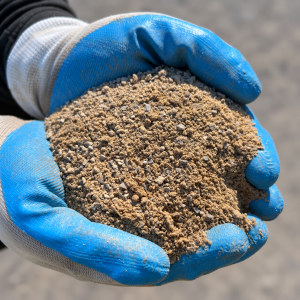Crusher Dust vs Roadbase Metal Dust held in blue and white gloves