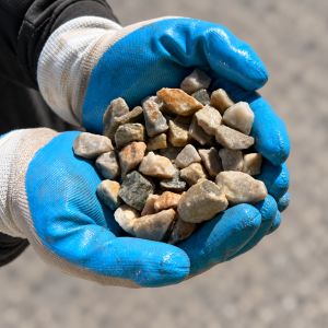 20mm Southern White Peach Gravel held in blue and white gloves
