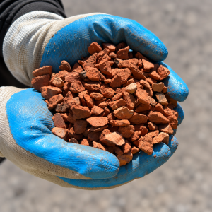 10mm Crushed Terracotta Tile held in blue and white gloves