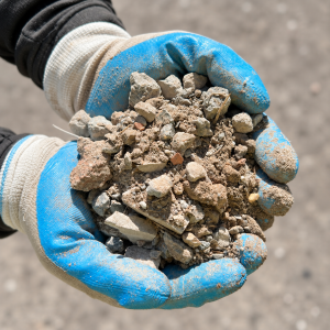 Crusher Dust vs Roadbase Recycled Roadbase held in blue and white gloves