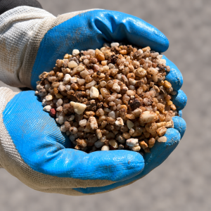 Country Stone Pea Gravel 5-7mm held in blue and white gloves