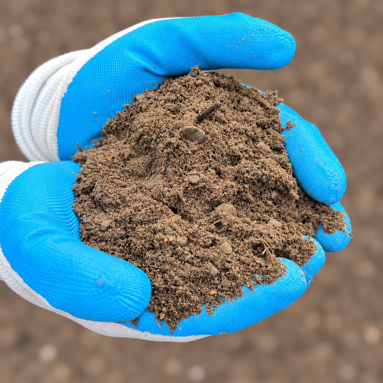 Commercial Underlay – square gloved sample Commercial Underlay held in blue and white gloves against softly blurred ground